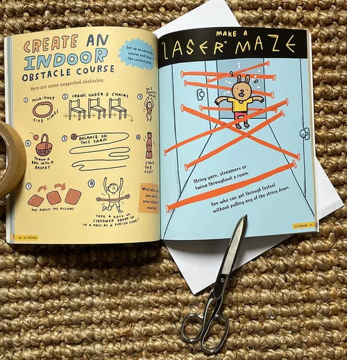 Open book with activities for creating an indoor obstacle course and a laser maze, with scissors on a textured surface.