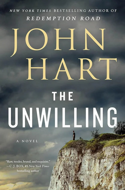 Book cover of 'The Unwilling' by John Hart with a person on a cliff under a stormy sky.